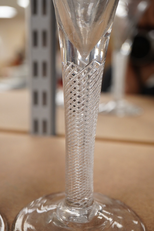 Three 18th century trumpet glasses, two with air twist stems (one with folded foot), together with another with a knopped stem and tear, tallest 16.5cm high